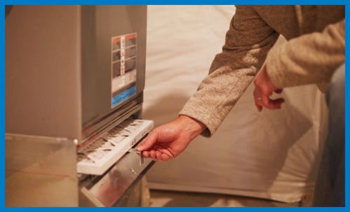 technician looking at furnace filter
