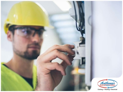 man adjusting switch