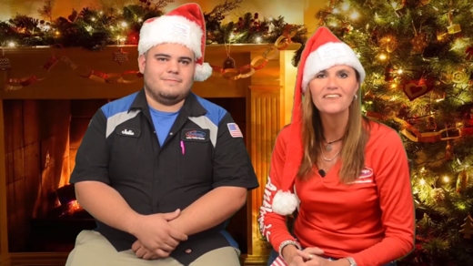Julio and Eric in front of a christmas tree.