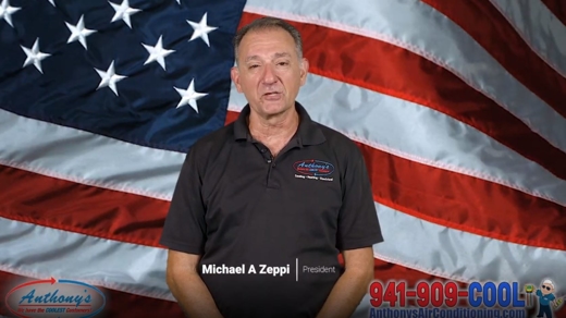 Mike Zeppi in front of an American flag.