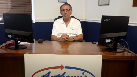 Mike Zeppi sitting at a desk with two monitors.