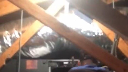 Tech working in an attic.